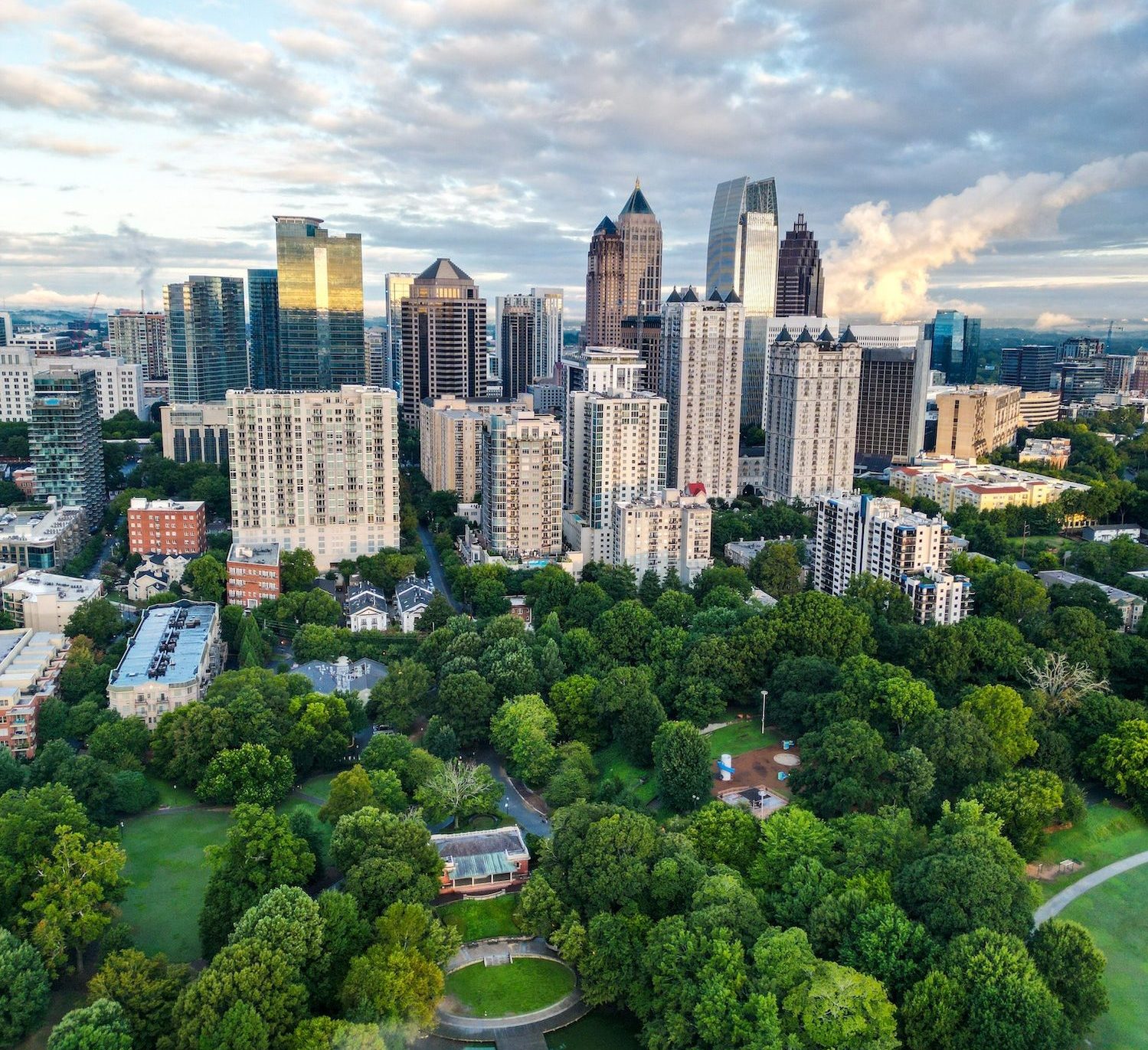 Vertical drone view of the Downtown Atlanta with modern buildings and a large green park, Georgia